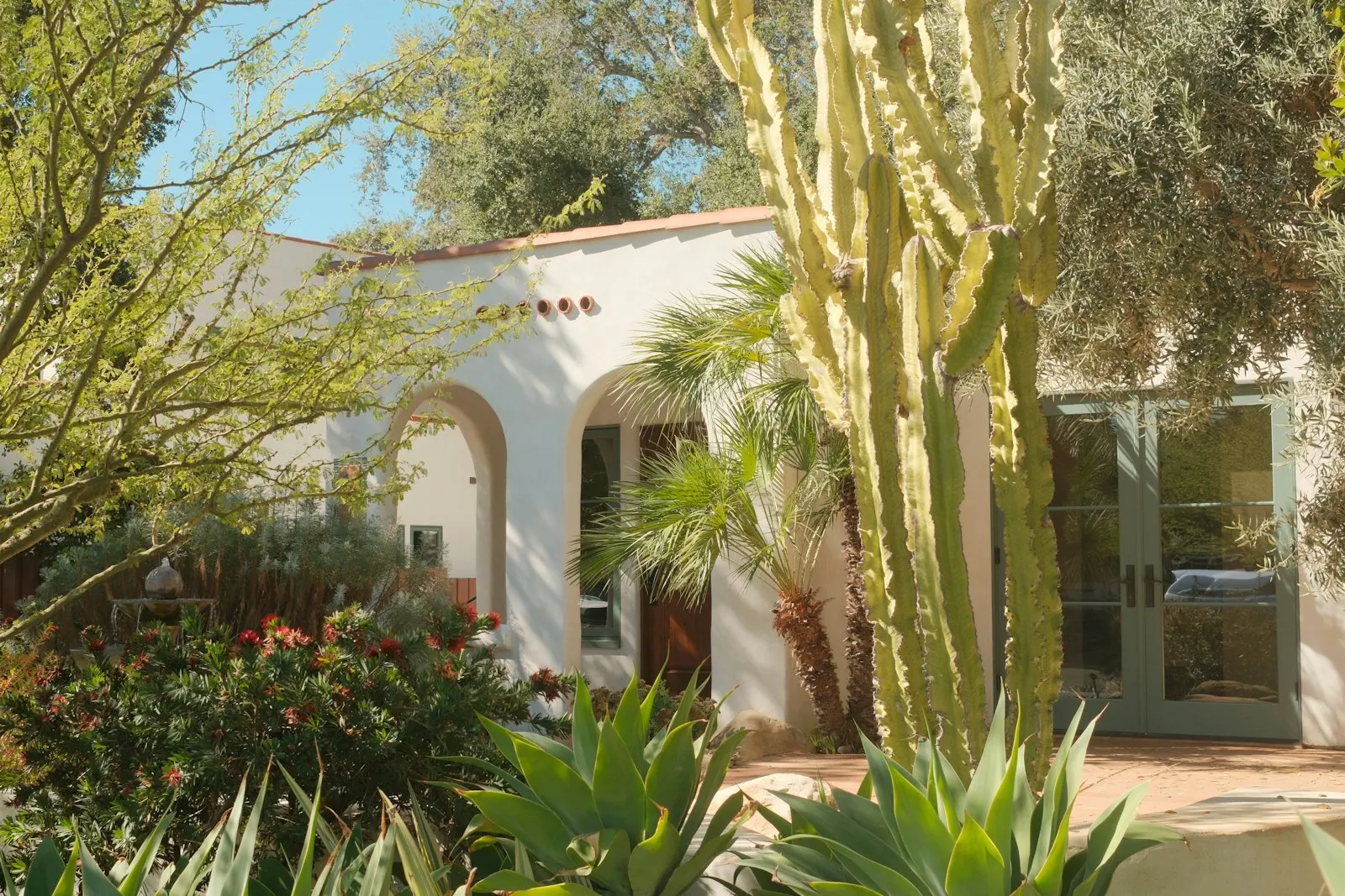 Spanish-style home with desert landscaping and built-in features