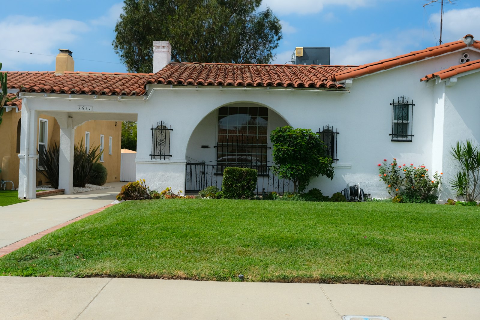 Stucco house with tile roof and gravel desert front yard